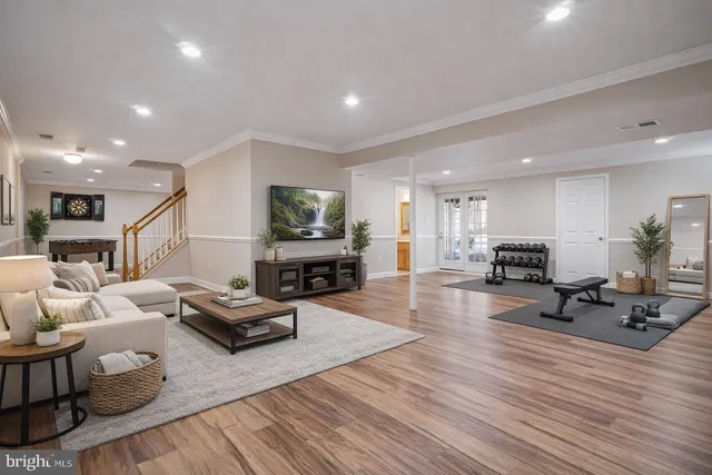 a view of an empty room with wooden floor and closet