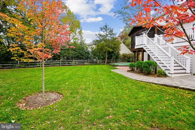 a view of a backyard with swimming pool