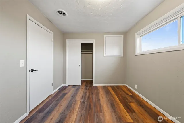 a view of a room with wooden floor