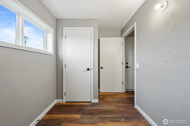 a view of room with window and wooden floor