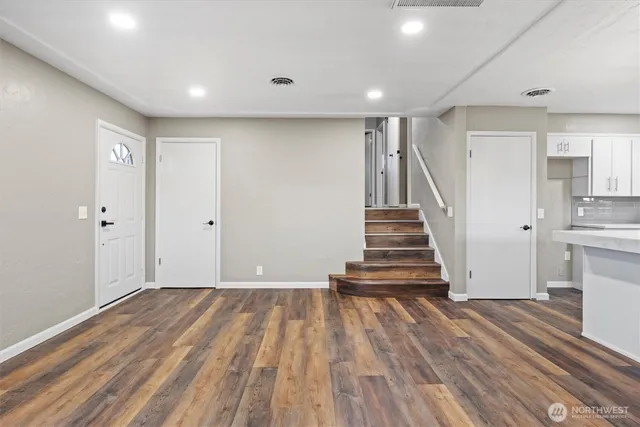 a view of a room with wooden floor and stairs