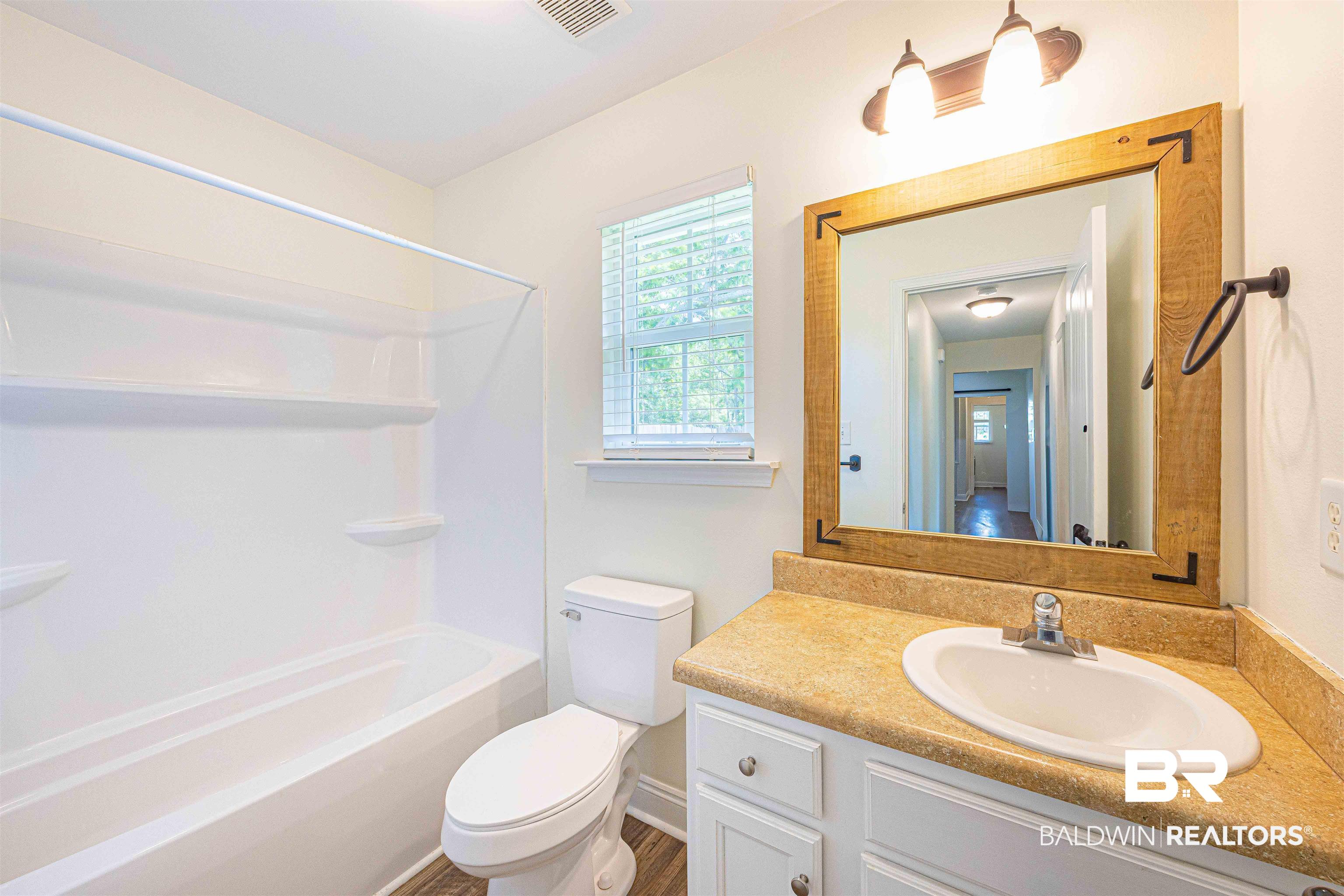 18675 Explorer Drive Loxley, AL 36551 - Photo 33 of 42 Full bathroom with toilet, vanity, and shower combination
