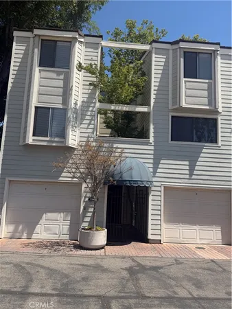 a view of a house with a garage and balcony
