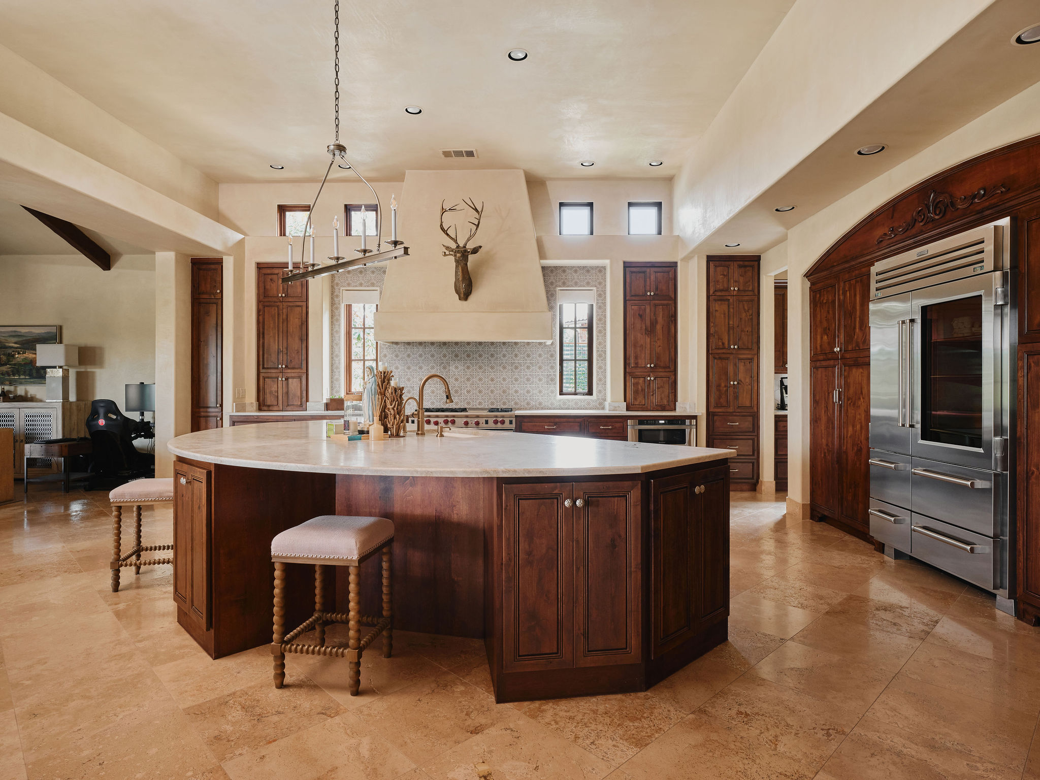 433 Brandon Way Austin, TX 78733 - Photo 10 of 40 A grand central island anchors this kitchen, offering ample counter space and integrated storage.