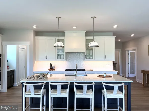 a kitchen that has a table and chairs in it