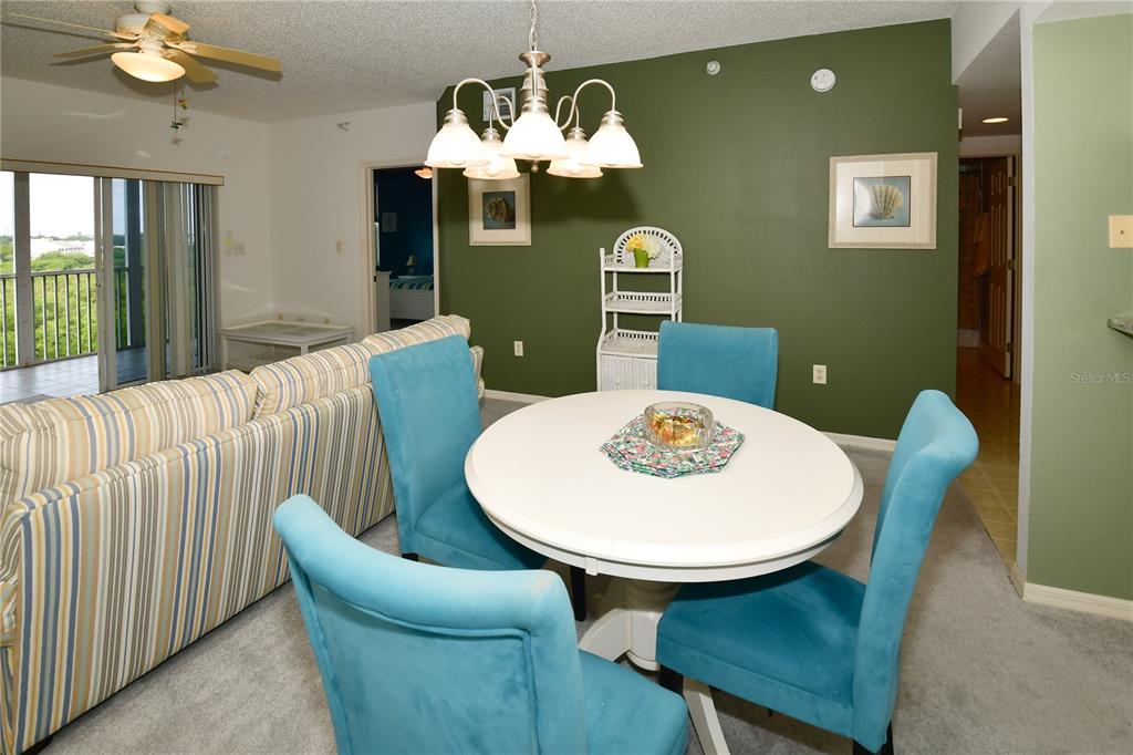 6450 Shoreline Drive, Unit 9405 St. Petersburg, FL 33708 - Photo 11 of 36 a view of a dining room with furniture and wooden floor