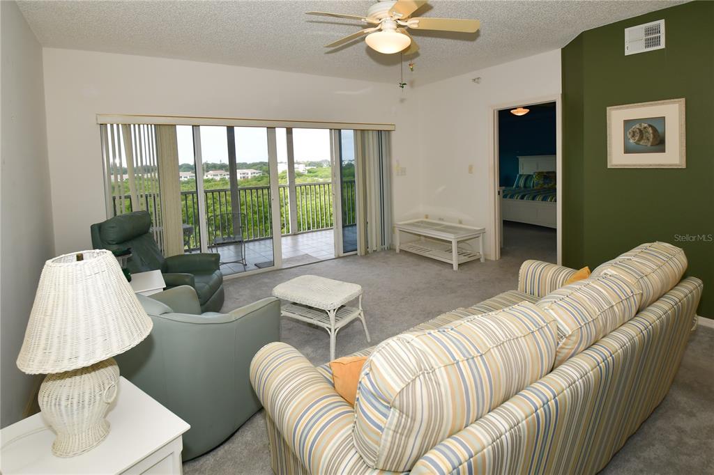 6450 Shoreline Drive, Unit 9405 St. Petersburg, FL 33708 - Photo 12 of 36 a living room with furniture and a large window