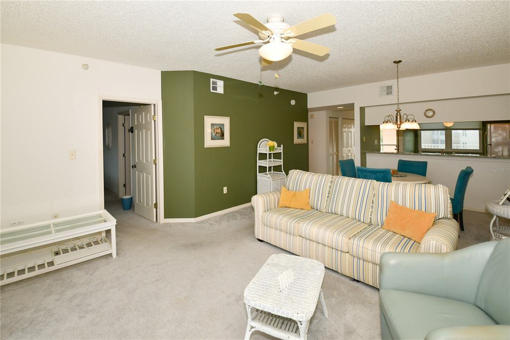 6450 Shoreline Drive, Unit 9405 St. Petersburg, FL 33708 - Photo 14 of 36 a living room with furniture and a chandelier