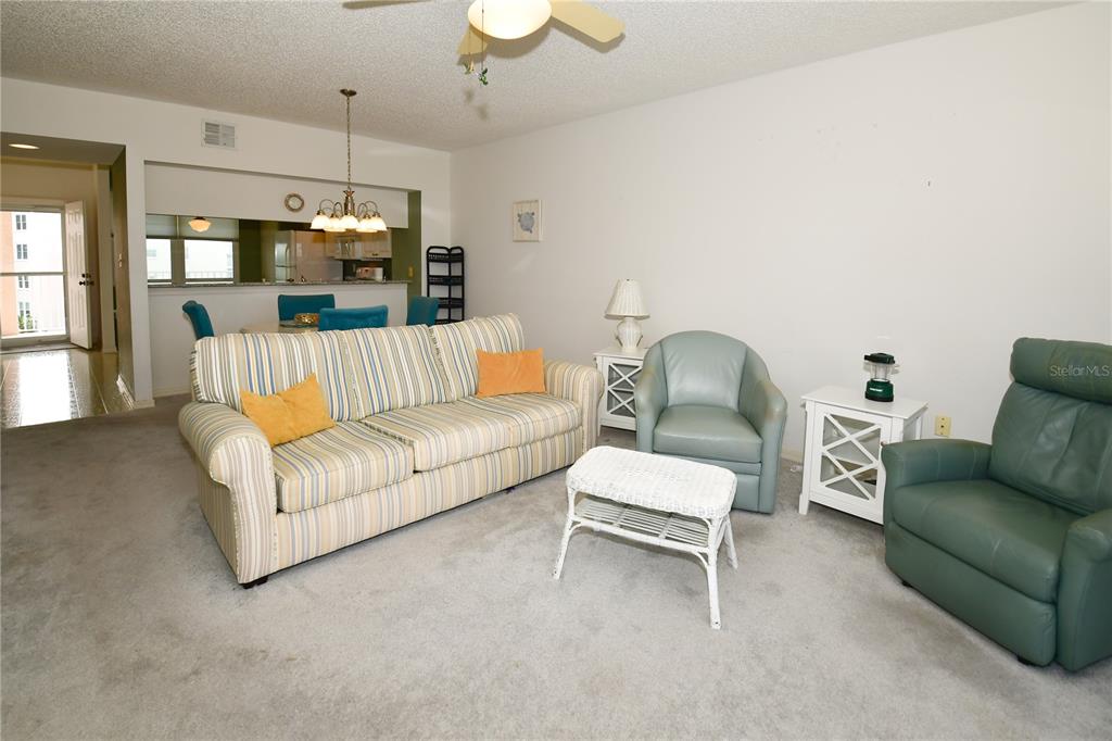 6450 Shoreline Drive, Unit 9405 St. Petersburg, FL 33708 - Photo 15 of 36 a living room with furniture and a chandelier