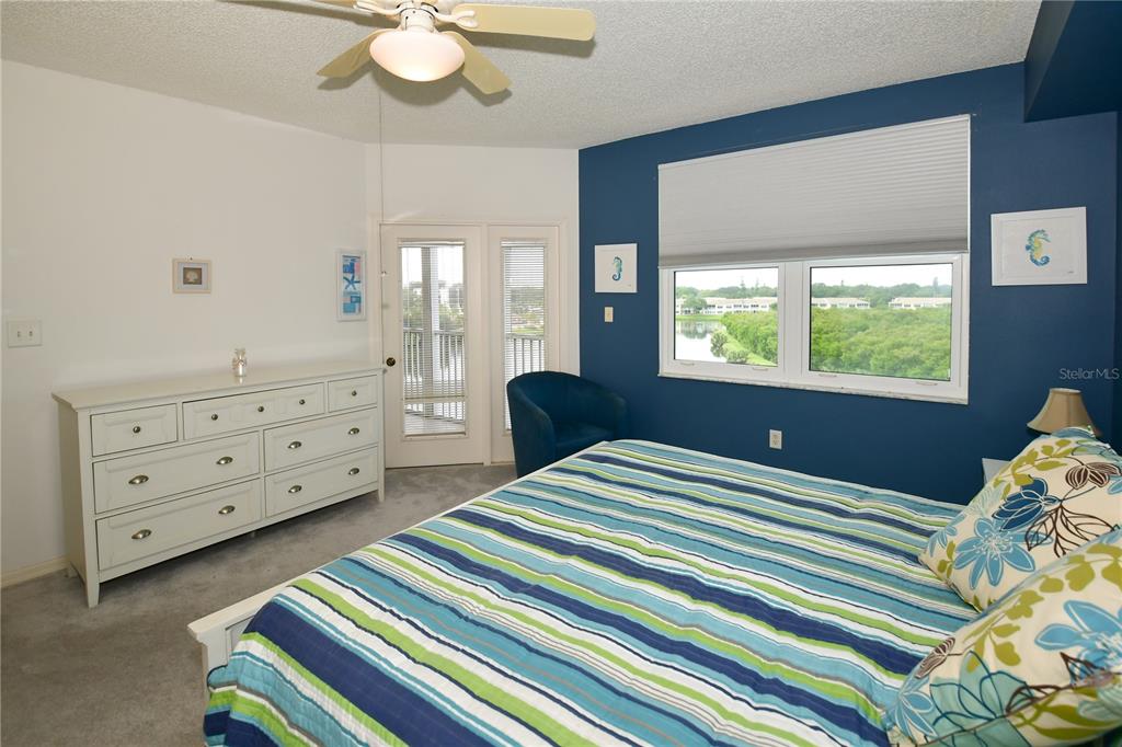 6450 Shoreline Drive, Unit 9405 St. Petersburg, FL 33708 - Photo 18 of 36 a bedroom with a bed and a dresser
