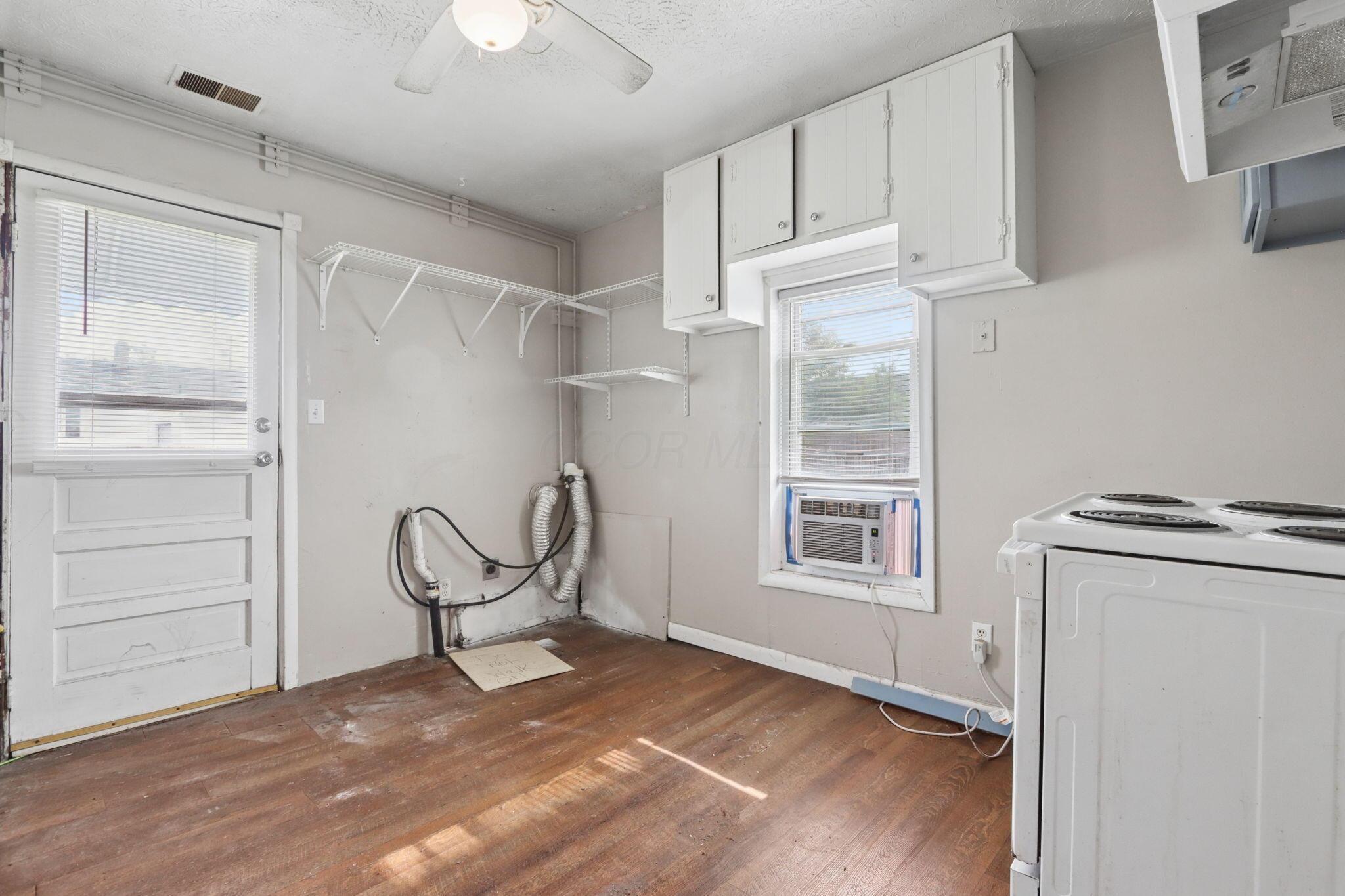 1128 Hilock Road Columbus, OH 43207 - Photo 10 of 29 Kitchen featuring laundry area and exterior access.