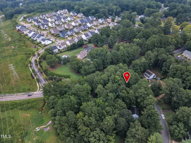 an aerial view of a house with a yard and lake view