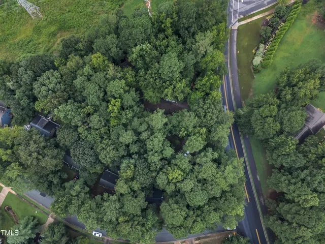 an aerial view of a house with a yard and lake view