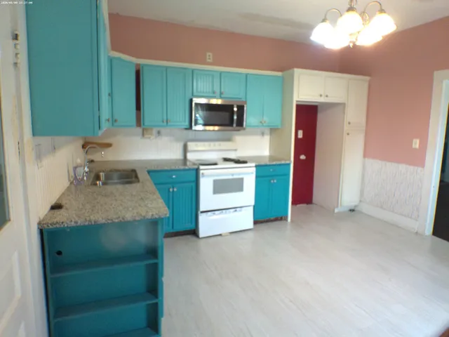 a kitchen with stainless steel appliances granite countertop a stove and a sink