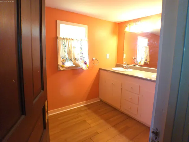 a view of a bathroom with a sink and a mirror