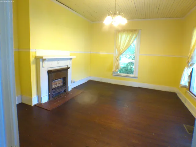 a view of empty room with a fireplace and fan