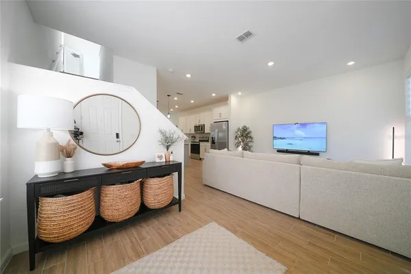 a living room with furniture and wooden floor
