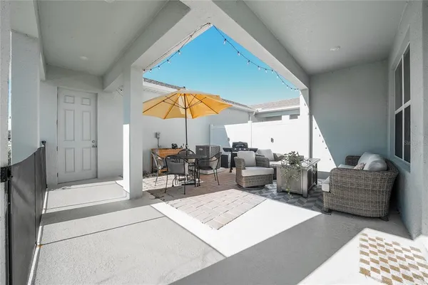 a living room with furniture a table and chairs