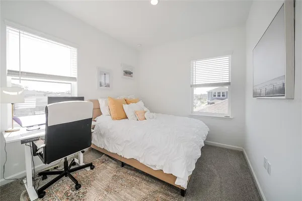 a bedroom with a bed and a desk