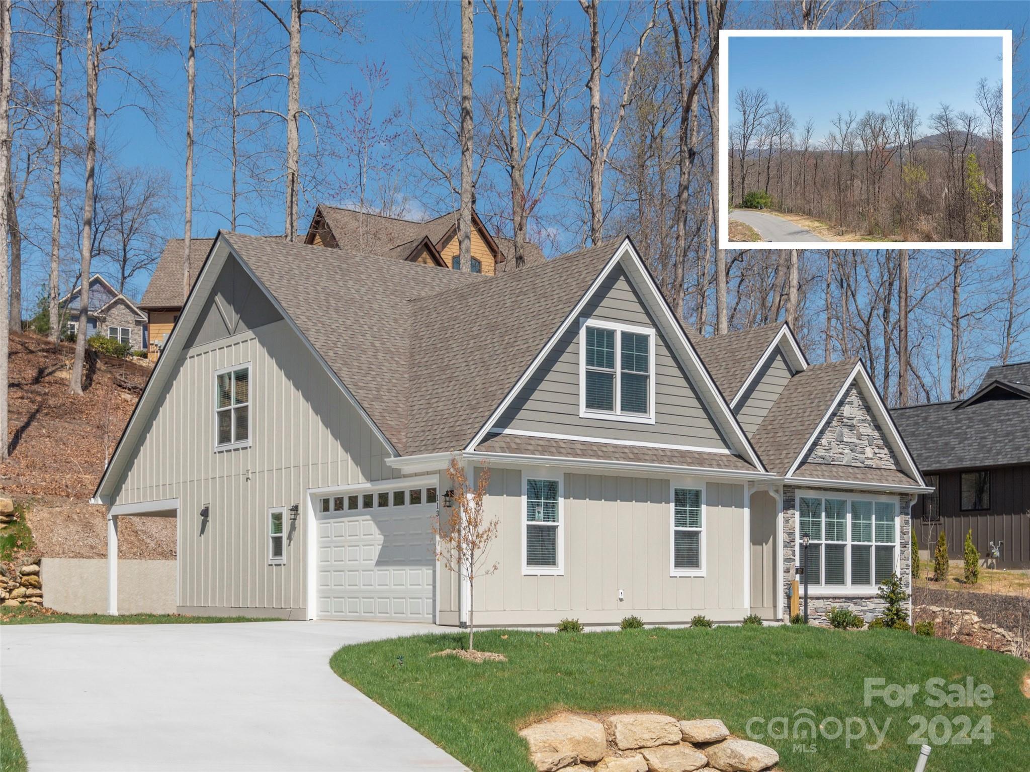 a front view of a house with a yard and potted plants