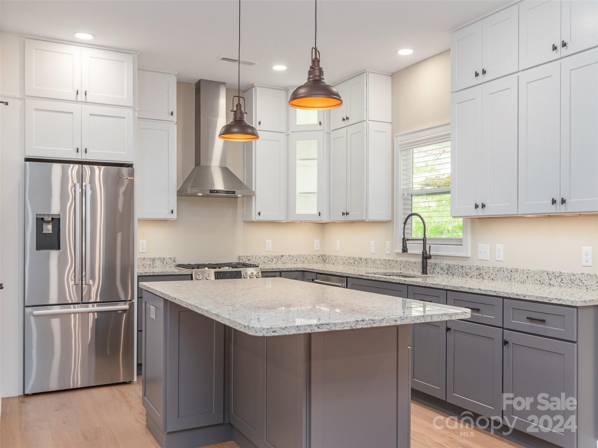113 Millbrae Loop Hendersonville, NC 28791 - Photo 11 of 35 a kitchen with stainless steel appliances granite countertop a sink a refrigerator and a stove