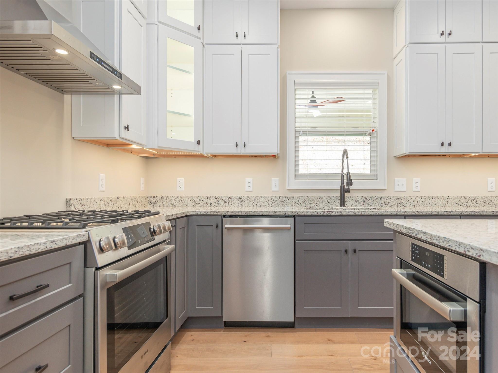 113 Millbrae Loop Hendersonville, NC 28791 - Photo 13 of 35 a kitchen with stainless steel appliances granite countertop a stove sink and cabinets