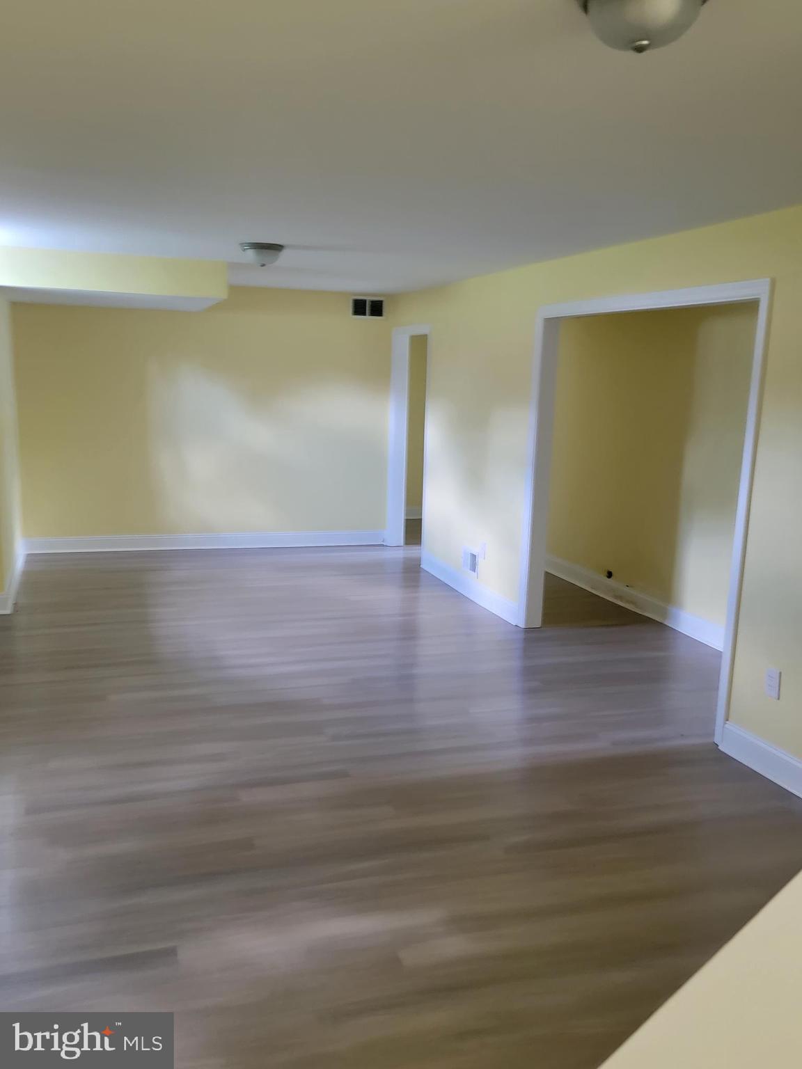 8300 Cathedral Avenue New Carrollton, MD 20784 - Photo 11 of 43 a view of an empty room with wooden floor