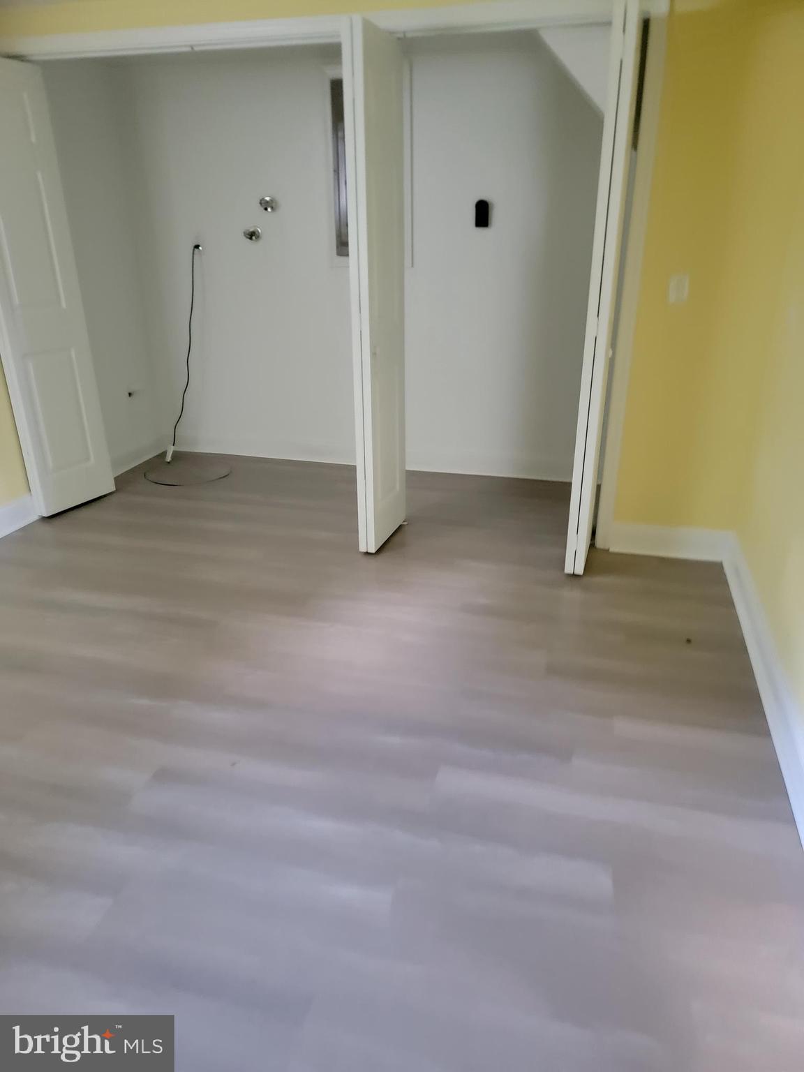 8300 Cathedral Avenue New Carrollton, MD 20784 - Photo 18 of 43 an empty room with wooden door