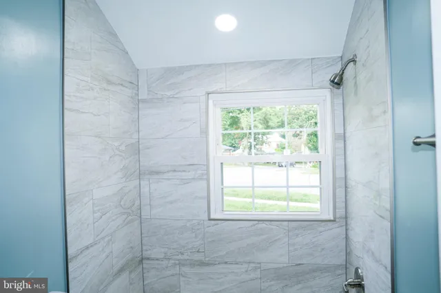 a bath tub sitting next to a white sink and a toilet
