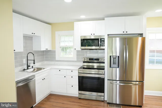 a bathroom with a sink mirror and vanity