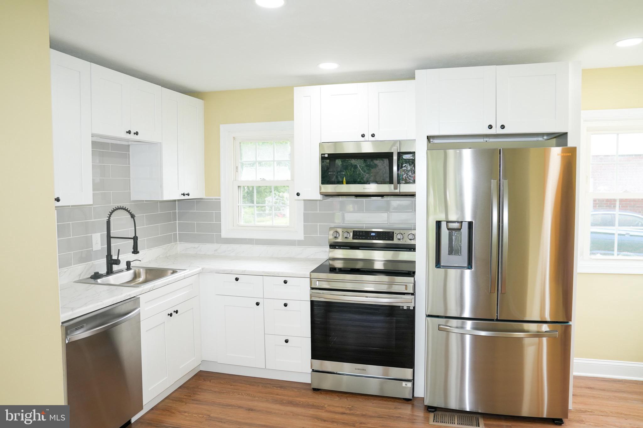 8300 Cathedral Avenue New Carrollton, MD 20784 - Photo 36 of 43 a kitchen with stainless steel appliances a refrigerator stove and sink