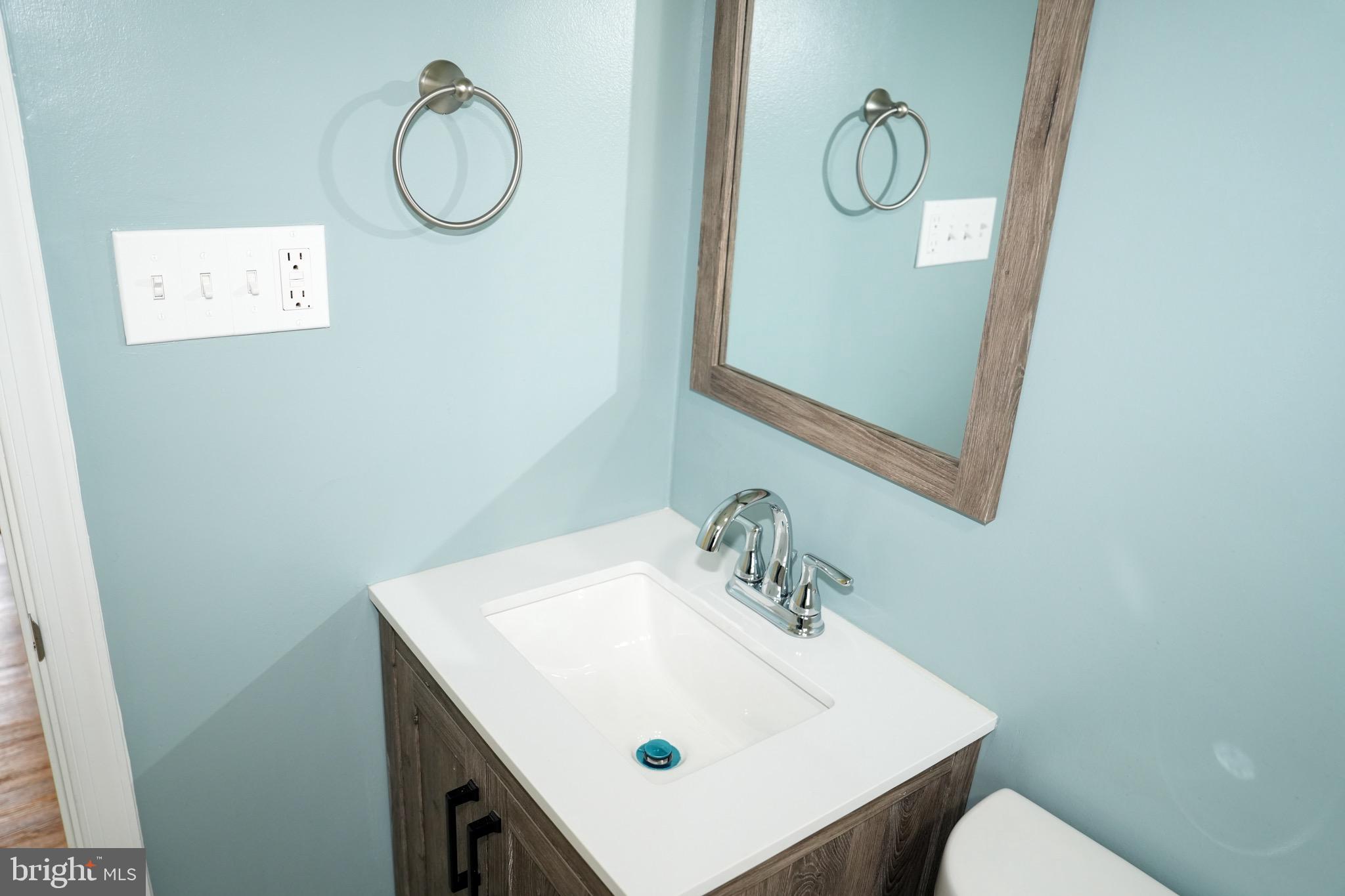 8300 Cathedral Avenue New Carrollton, MD 20784 - Photo 38 of 43 a bathroom with a sink mirror and vanity