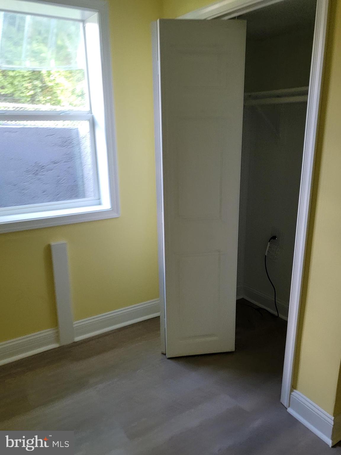 8300 Cathedral Avenue New Carrollton, MD 20784 - Photo 4 of 43 a view of a small space with wooden floor and a window