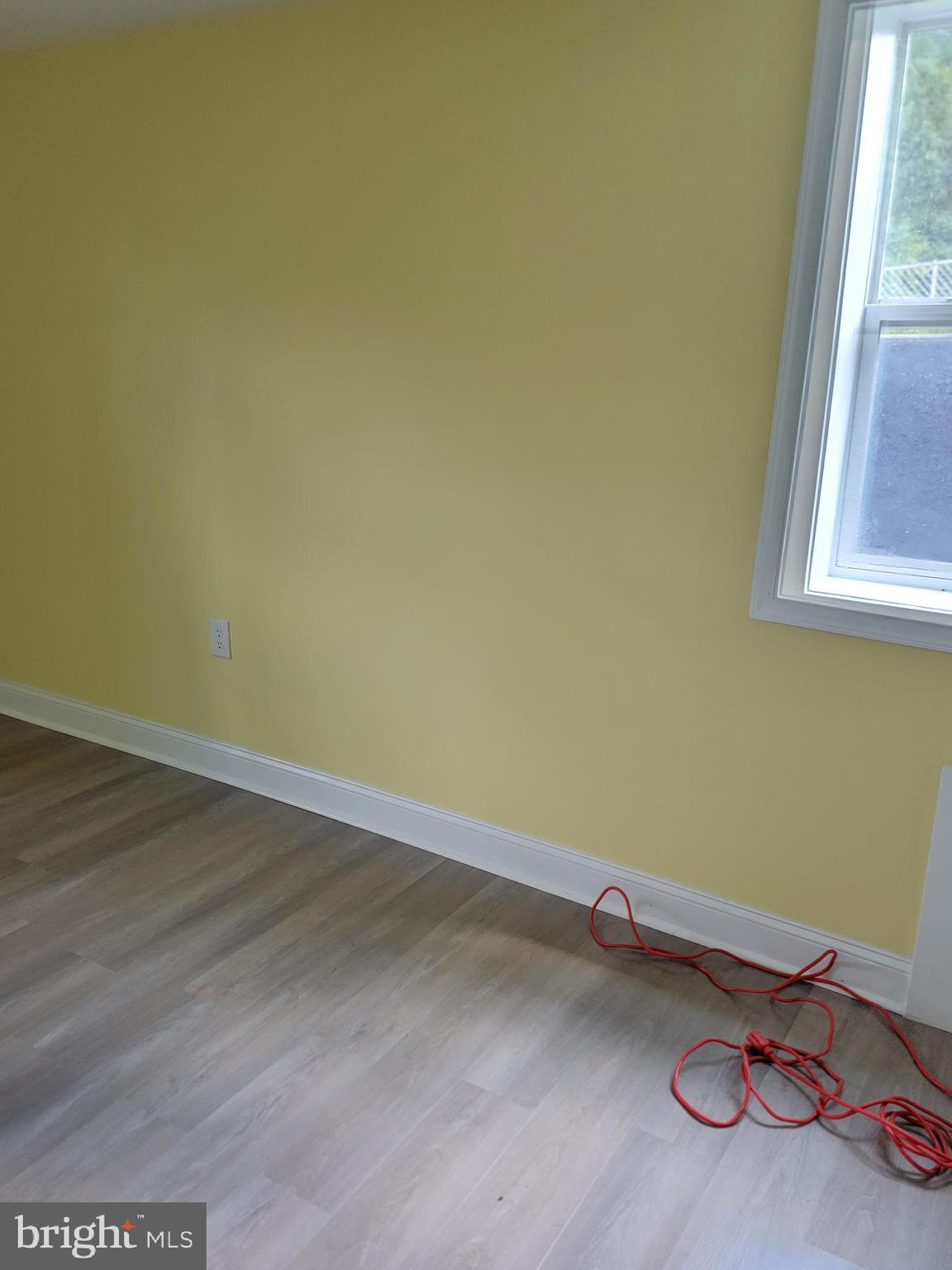 8300 Cathedral Avenue New Carrollton, MD 20784 - Photo 8 of 43 a room with a wooden floor and a window