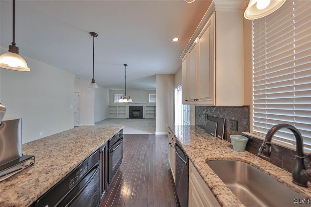 41 Joy Circle Barto, PA 19504 - Photo 19 of 57 a kitchen with stainless steel appliances granite countertop a sink a stove and a wooden floors