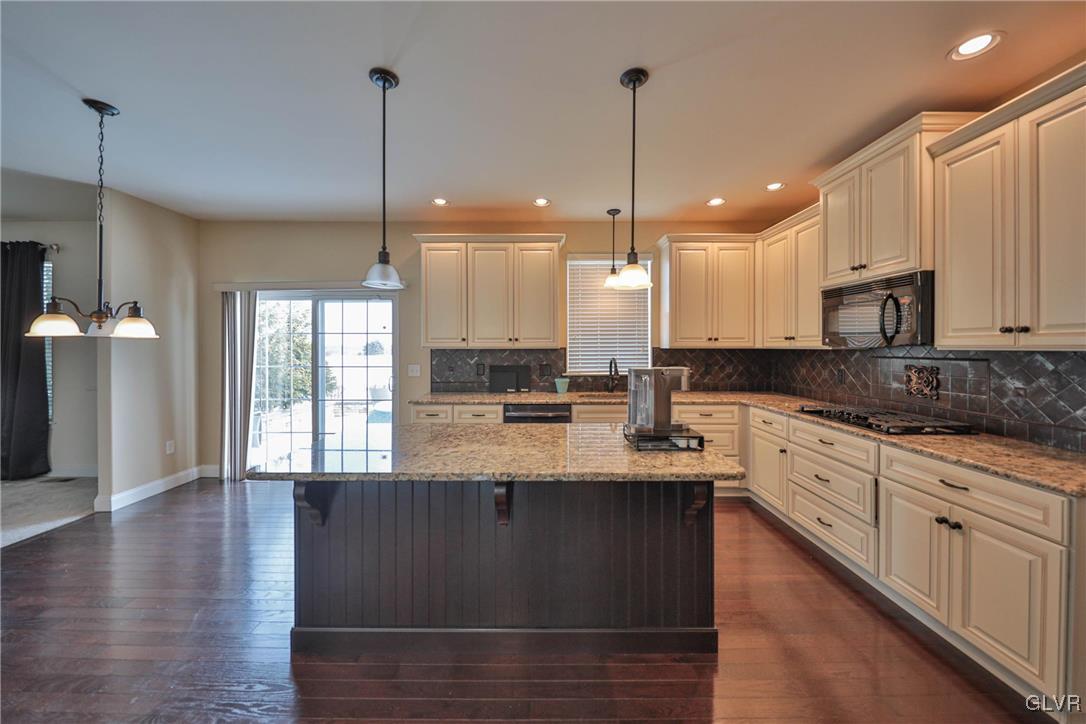 41 Joy Circle Barto, PA 19504 - Photo 21 of 57 a large kitchen with granite countertop a stove a sink a center island and wooden floor