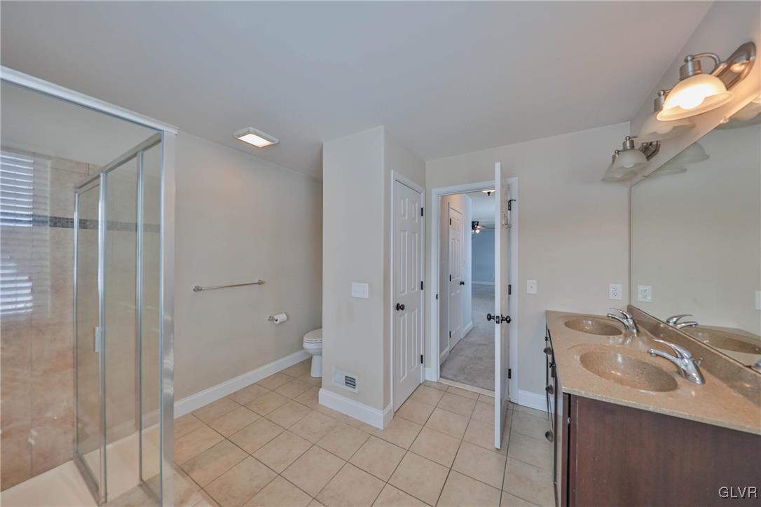 41 Joy Circle Barto, PA 19504 - Photo 31 of 57 a spacious bathroom with a granite countertop sink a mirror and a shower