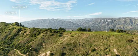 a view of a town with mountains in the background