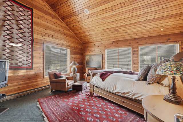 6 Beaver Springs Rancheros Oakley, UT 84055 - Photo 23 of 68 Vaulted wood-paneled ceilings and walls define this space, featuring multiple windows with horizontal blinds