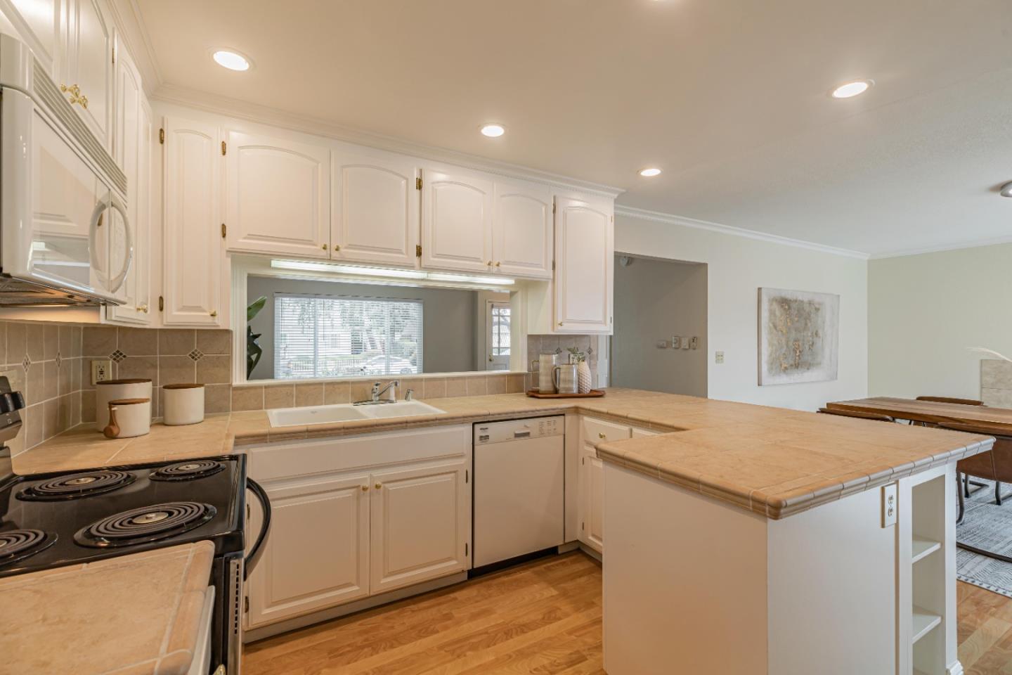 1298 Reeve Street Santa Clara, CA 95050 - Photo 16 of 28 a kitchen with a sink stove and cabinets