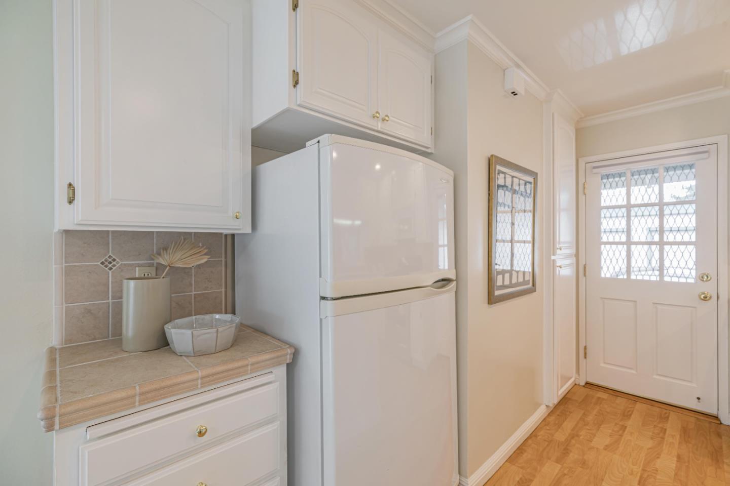 1298 Reeve Street Santa Clara, CA 95050 - Photo 17 of 28 a white refrigerator freezer sitting in a kitchen