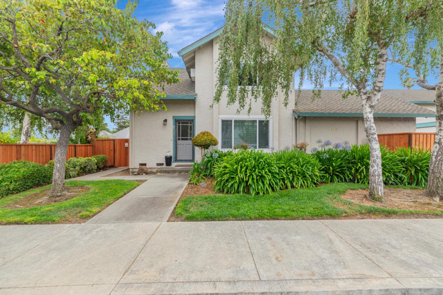 1298 Reeve Street Santa Clara, CA 95050 - Photo 2 of 28 a view of a white house next to a yard with potted plants and trees