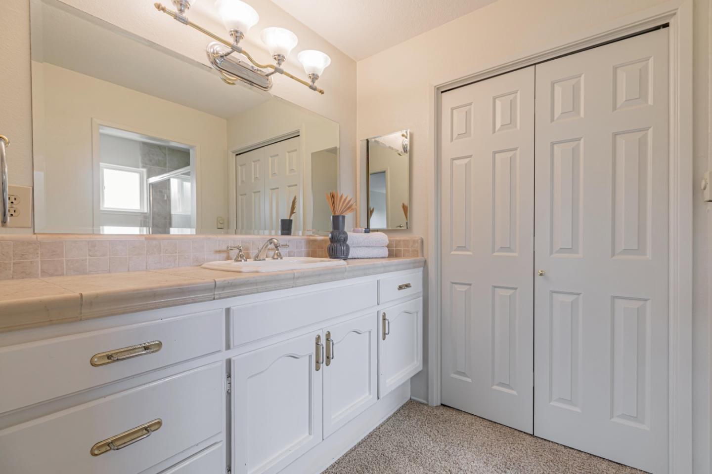 1298 Reeve Street Santa Clara, CA 95050 - Photo 23 of 28 a bathroom with a double vanity sink and a mirror