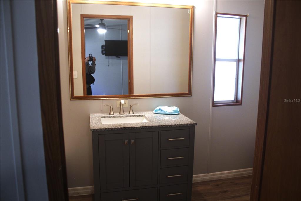 24427 Wild Turkey Road Paisley, FL 32767 - Photo 13 of 55 a bathroom with a sink and a mirror
