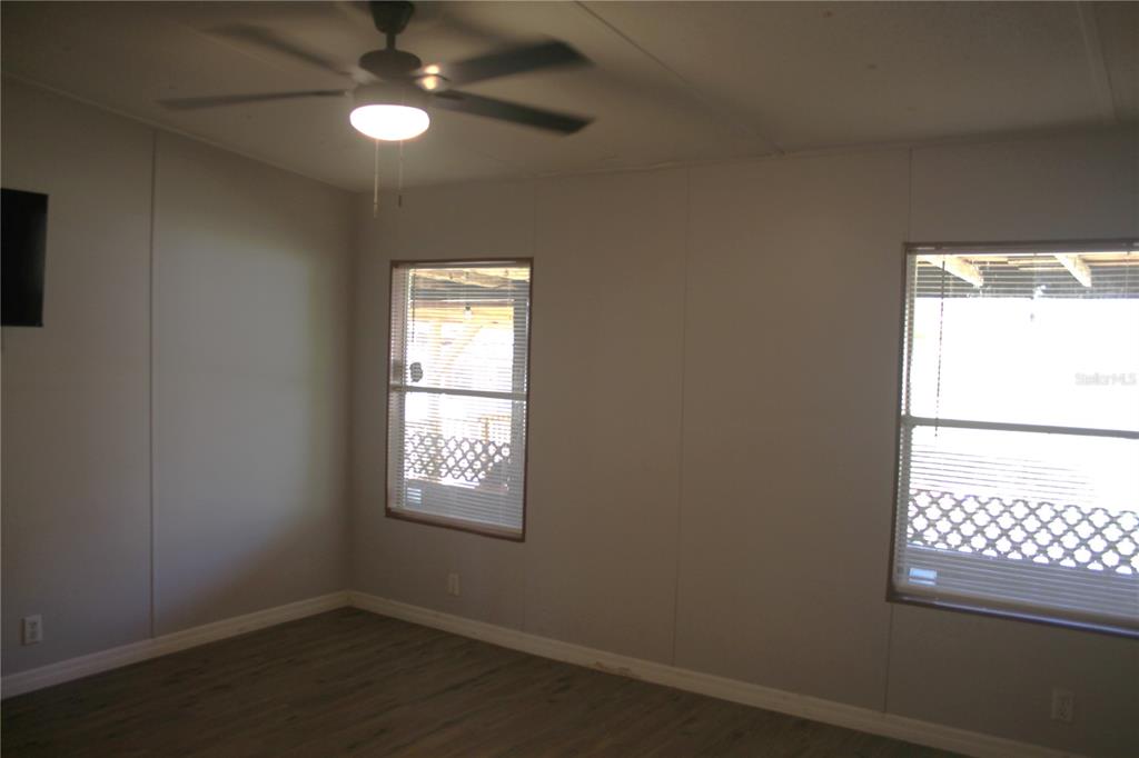 24427 Wild Turkey Road Paisley, FL 32767 - Photo 15 of 55 an empty room with windows and fan