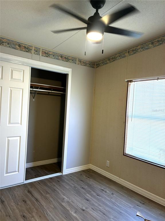 24427 Wild Turkey Road Paisley, FL 32767 - Photo 17 of 55 an empty room with wooden floor cabinet and windows
