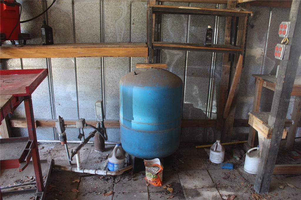 24427 Wild Turkey Road Paisley, FL 32767 - Photo 29 of 55 a room with water heater and wooden cabinets