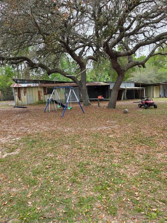 24427 Wild Turkey Road Paisley, FL 32767 - Photo 37 of 55 a backyard of a house with seating space