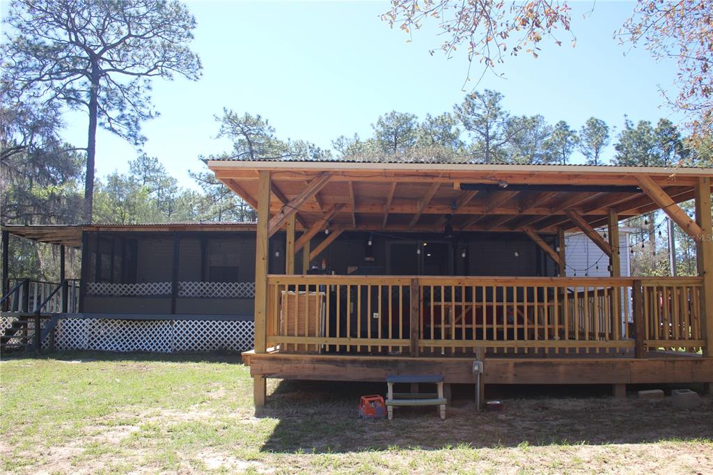 24427 Wild Turkey Road Paisley, FL 32767 - Photo 43 of 55 a view of a roof deck with wooden floor and fence