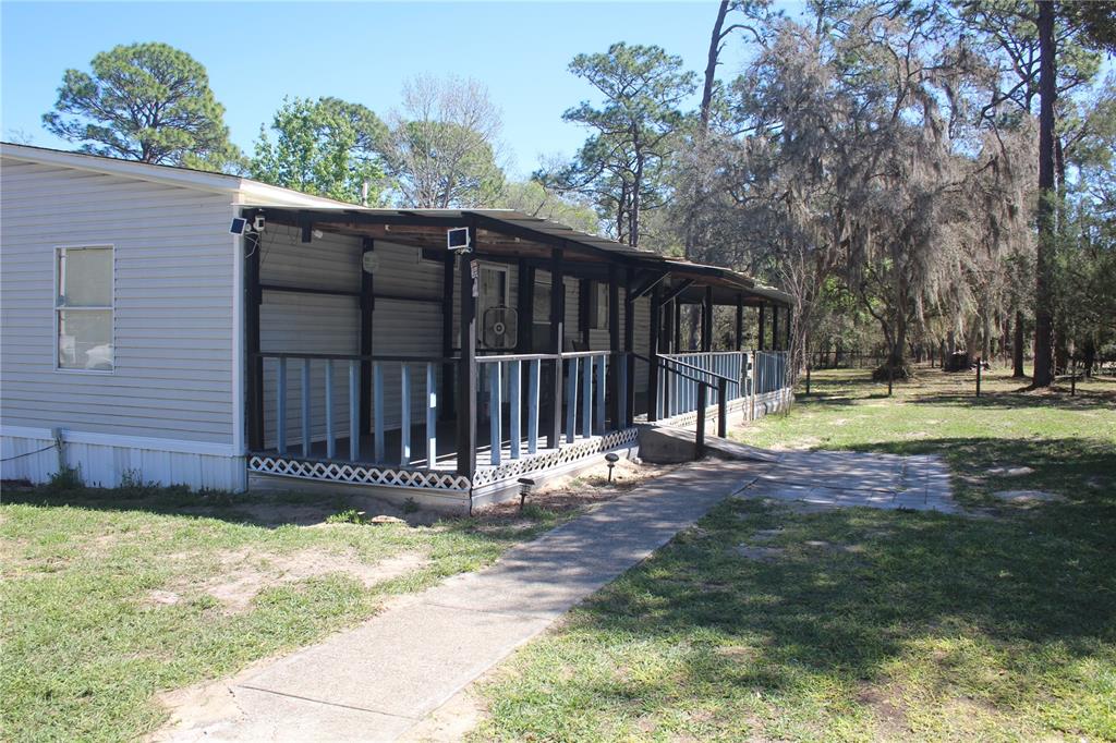24427 Wild Turkey Road Paisley, FL 32767 - Photo 46 of 55 a view of a house with a small yard and wooden fence